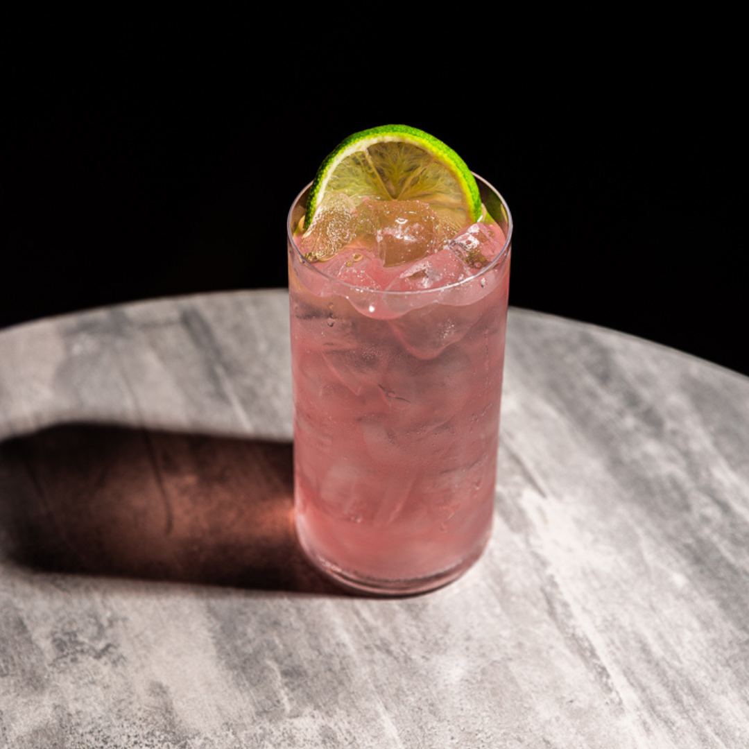 An aromatic twist on rakija and soda, mixed in a tall glass with a lime garnish