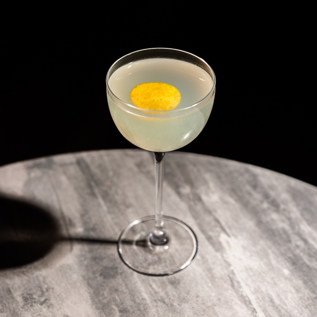 The Kiss Kiss, Bang Bang cocktail with a twist of lemon is a riff on a Mai Tai using rakija instead of rum.